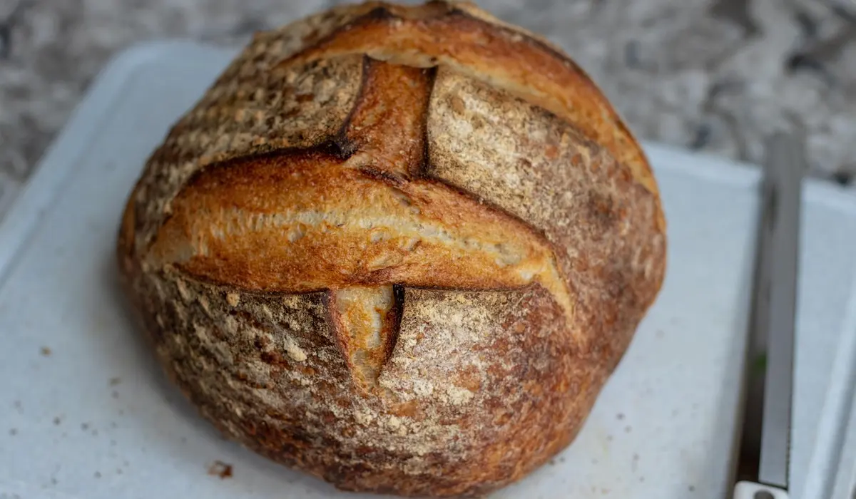 Crusty round loaf of bread on a cutting board