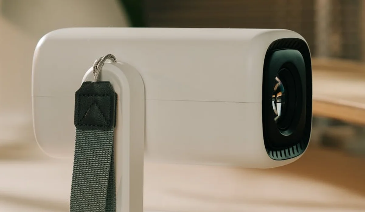White compact air purifier mounted on a stand, shown from the side in a home setting.