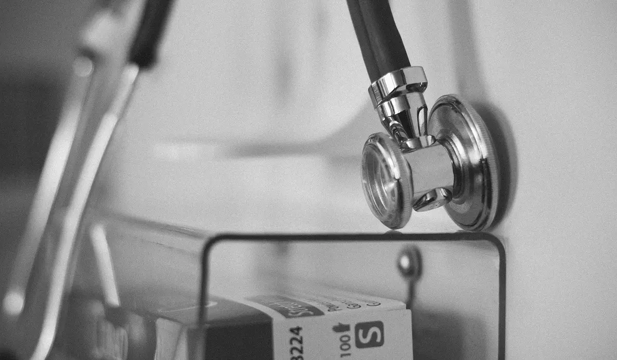 Stethoscope and medication bottle in a veterinary setting, representing preventive care during parrot annual check-ups.