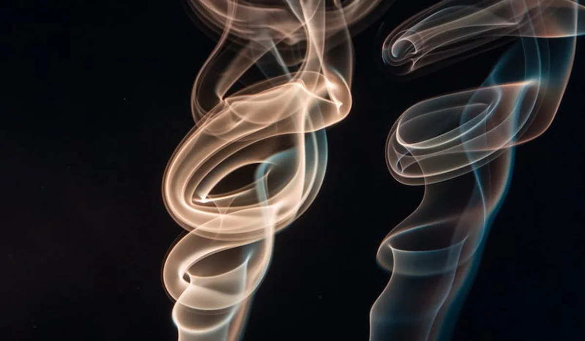 Abstract wisps of smoke on a dark background, symbolizing air quality control